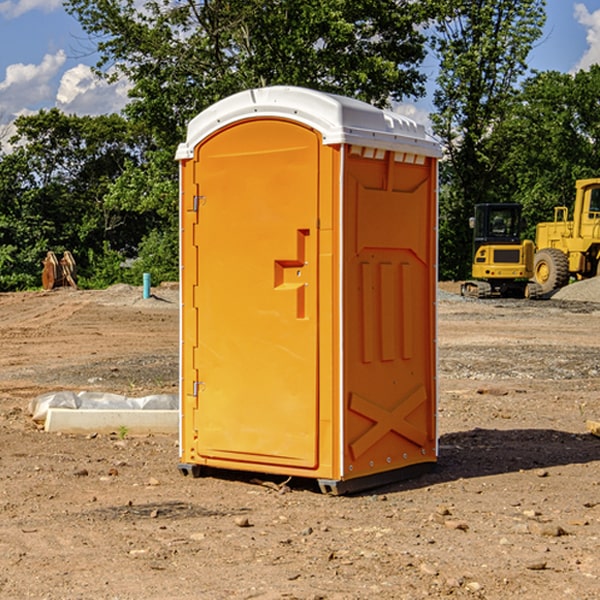 what is the cost difference between standard and deluxe portable restroom rentals in Harbinger